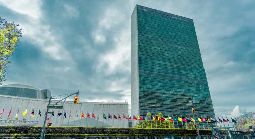 The UN main building and line of flags outside.