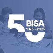 Two women working together at a BISA workshop, image with BISA anniversary logo