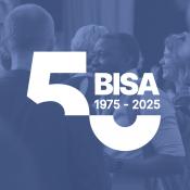 Two men networking together at a BISA workshop, image with BISA anniversary logo