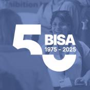 Two women talking at a BISA workshop, image with BISA anniversary logo