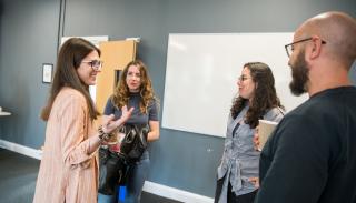 Attendees talking at a workshop