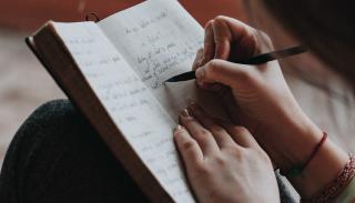 woman writing in a notebook