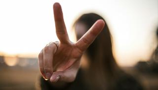 A woman giving the peace sign