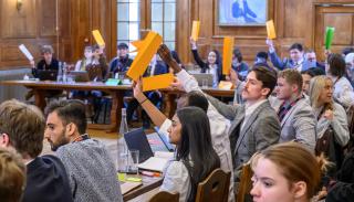 Students at the BISA climate simulation holding up country cards