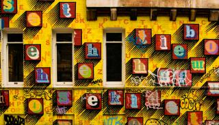 Letters on a bright yellow building facade