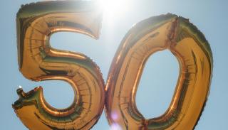 Gold 50 balloons with a blue sky in the background