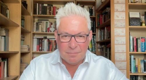 Tim Edmunds in an office with books in the background