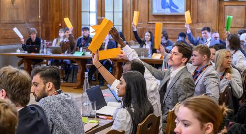 Students at the BISA climate simulation holding up country cards