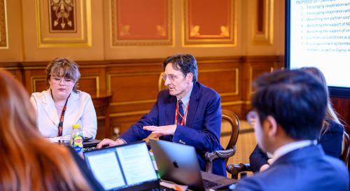 Professor Mark Webber engaging with a small group of students at the Foreign Office