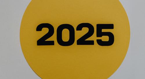 A yellow circle with 2025 written in black across the diameter