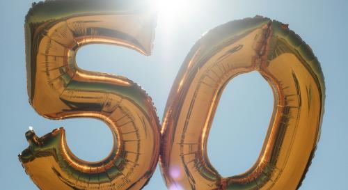 Gold 50 balloons with a blue sky in the background