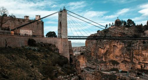 An image of a bridge stretched across a rocky ravine.