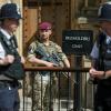 A picture of two uniformed policemen and a male paratrooper, holding a rifle, standing in front of the UK's parliament building and a sign stating 'passholders only'